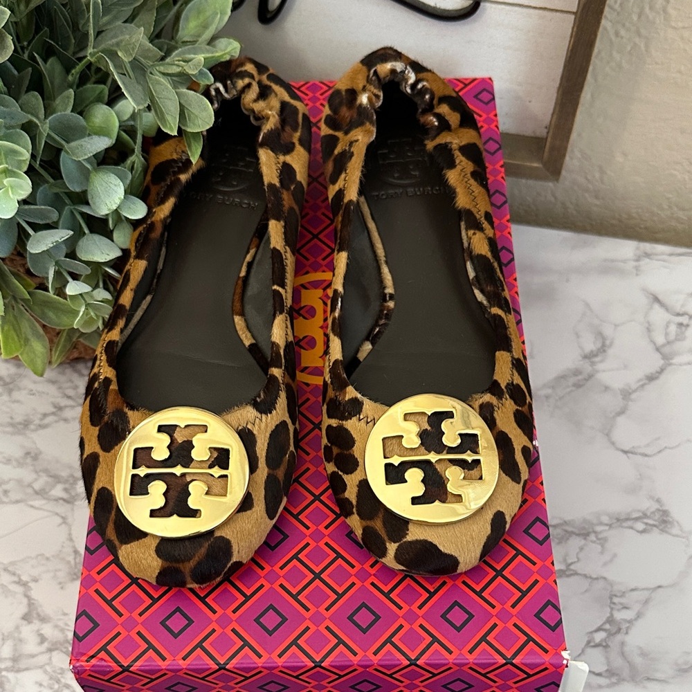 This is a pair of Tory Burch Reva ballet flats in leopard-print calf hair.